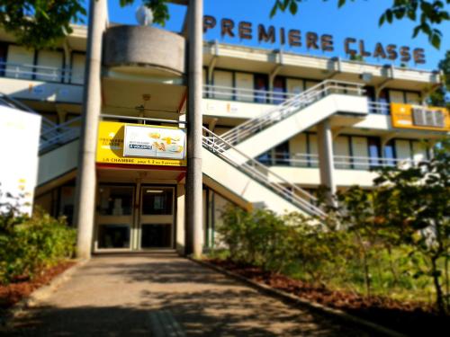 a building with a staircase in front of a building at Premiere Classe Nancy Est Essey in Essey-lès-Nancy