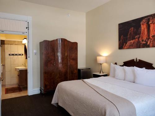 a hotel room with a large bed and a bathroom at Hotel Ouray - for 12 years old and over in Ouray