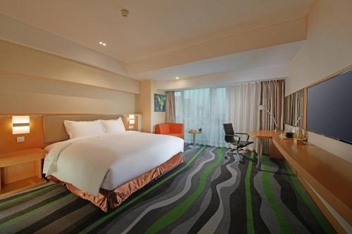 Ένα ή περισσότερα κρεβάτια σε δωμάτιο στο Holiday Inn Express Tangshan Downtown by IHG