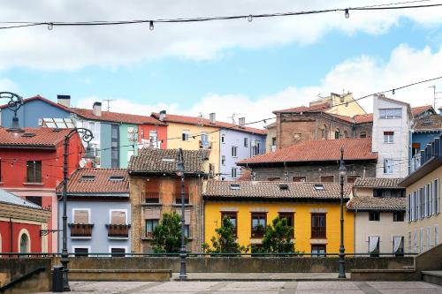 a view of a city with colorful buildings at TOP APARTMENT ÁTICO con TERRAZA con vistas al ENCIERRO SAN FERMÍN in Pamplona