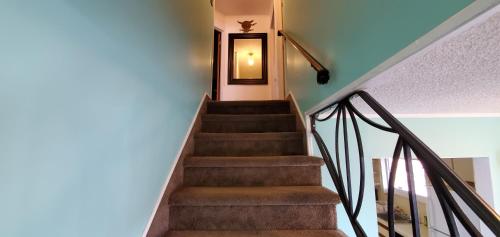 a staircase leading up to a door in a house at Pinebrook Motel in Lake George