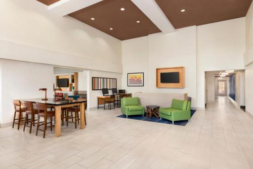 a living room filled with furniture and a kitchen at Holiday Inn Express & Suites Sarasota East, an IHG Hotel in Sarasota