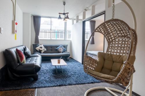 a living room with a couch and a swing at SUNDAY peace room 猿猴橋 #27 in Hiroshima