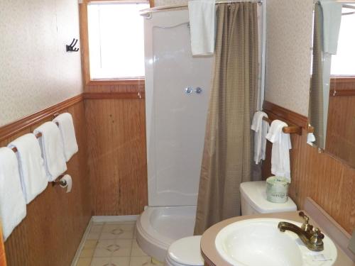 a bathroom with a sink and a toilet and a shower at Ocean Avenue Inn in Westport