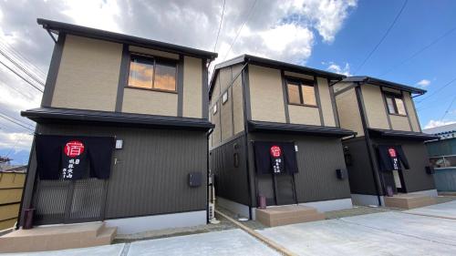 a large house with two entrances to it at Holiday home Furinkazan 風林火山 in Fujikawaguchiko