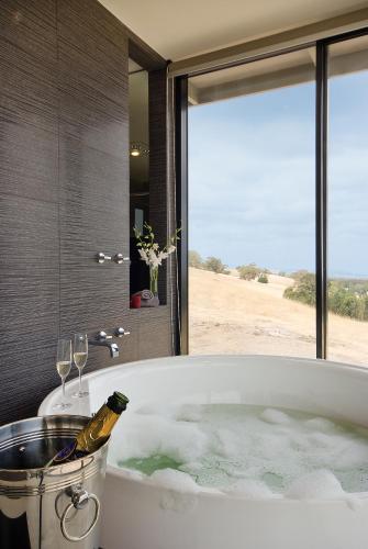 a bath tub with a bottle of champagne in it at McLaren Eye in Kangarilla