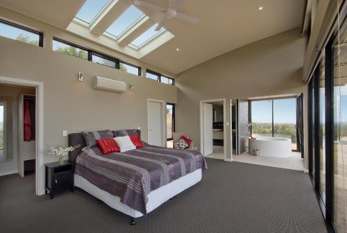 a bedroom with a bed and a large window at McLaren Eye in Kangarilla