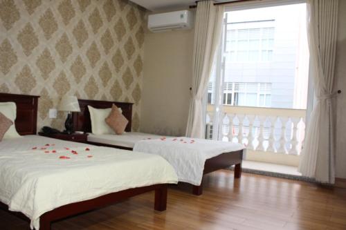 Postel nebo postele na pokoji v ubytování NGỌC MẤY - ĐẠI LỢI HOTEL