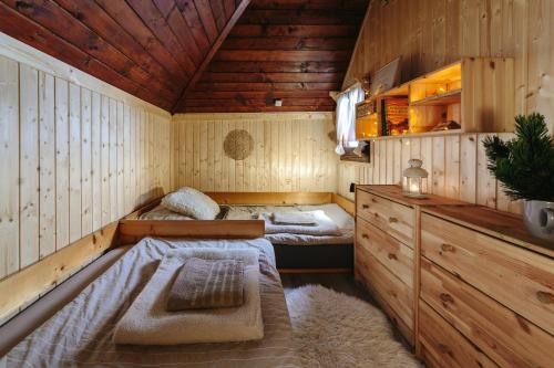 a room with two beds in a wooden cabin at Chalet Tisa Velika Planina in Stahovica