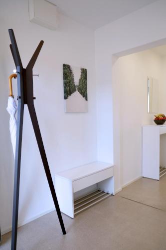 a white bench against a white wall in a room at CITY STAY - Forchstrasse in Zürich