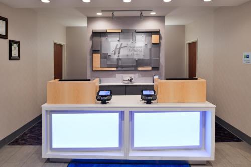a waiting room with two chairs and a table at Holiday Inn Express Hotel & Suites Clifton Park by IHG in Clifton Park