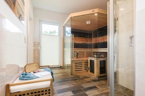 a room with a glass closet with a stove at Neu!!! Ferienhaus-See-Sauna-Kamin-5 Sterne-102m² in Krakow am See