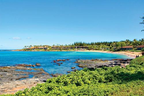 a sandy beach with a view of the ocean at Napili Shores Maui by Outrigger - No Resort & Housekeeping Fees in Lahaina