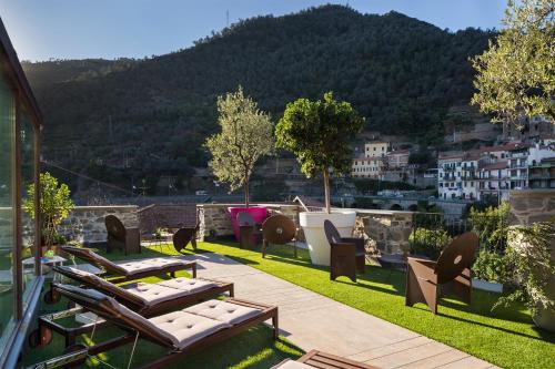 a balcony with lounge chairs and a view of a city at Agriturismo l'Adagio in Badalucco