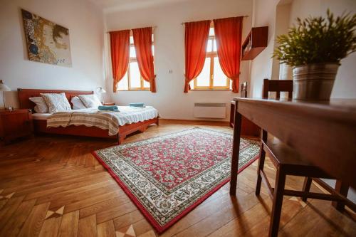 a living room with a bed and a rug at Hotel Stein Elbogen in Loket