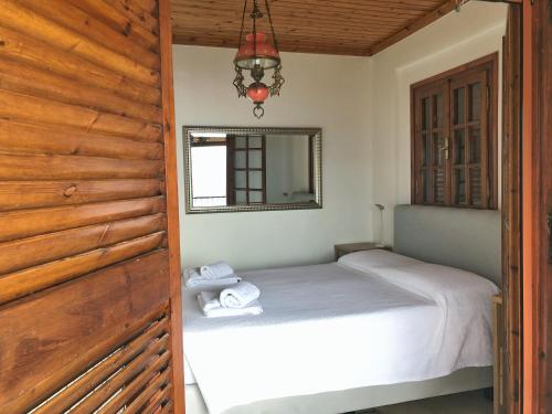 a bedroom with a bed and a wooden wall at Gaia (Γαία) guest house in Kalamata
