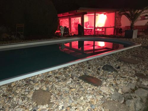a swimming pool in front of a house at night at Haus am Pool in Knautkleeberg