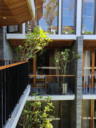 a facade of a building with trees in a courtyard at Mai's Boutique in Da Nang