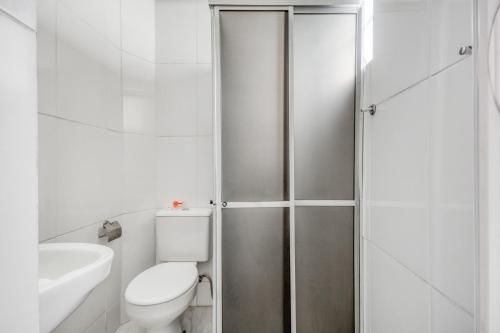 a bathroom with a shower with a toilet and a sink at Hotel Jardim do Cedro in Cedral