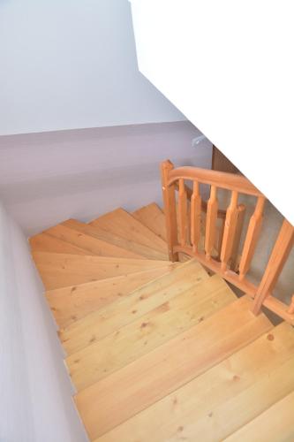 a wooden staircase in a room with wooden floors at Apartmá Kateřina Velké Losiny in Velké Losiny