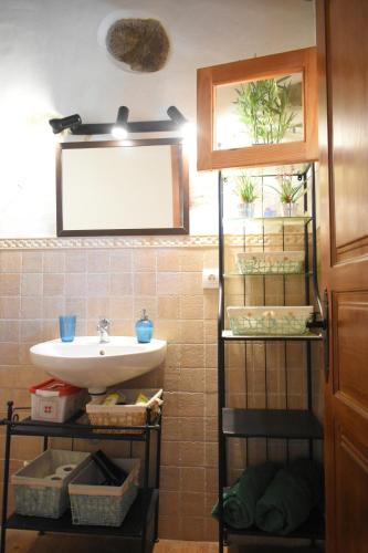 a bathroom with a sink and a mirror at Finca Mariola - Alpendre in San Bartolomé