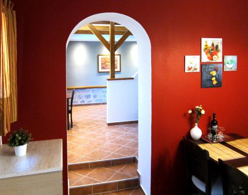 an archway leading into a dining room with red walls at Estia Holiday in Gythio