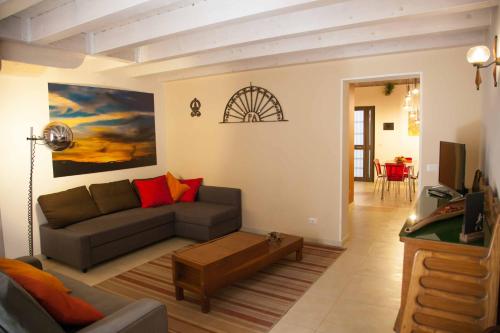 a living room with a couch and a table at Naturalmente abitare in Catania