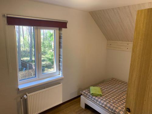 Postel nebo postele na pokoji v ubytování Kammelja Puhkemajad