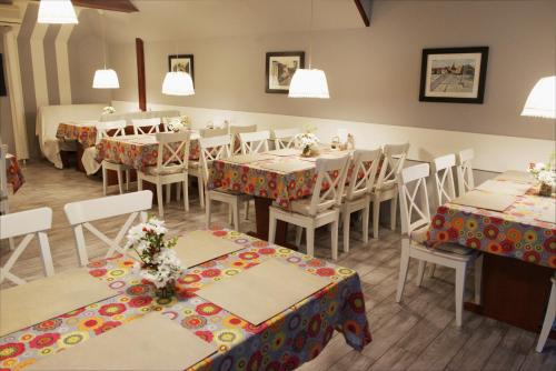 a restaurant with tables and chairs with flowers on them at REKLINIEC in Myślenice