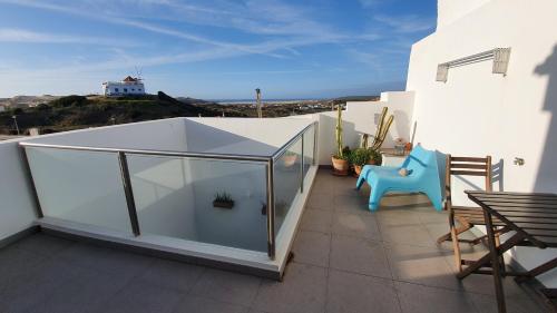 a balcony with a glass box on top of a building at Sea View Apartment Carrapateira in Carrapateira