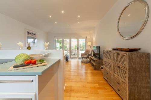 a kitchen with a counter and a mirror on the wall at Amaroo in St. Agnes 