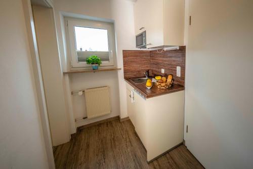 a small kitchen with a sink and a window at Haus Erli in Mittenwald