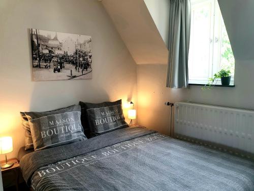 a bedroom with a bed with two pillows on it at Het Begijnhof Tongeren Center in Tongeren