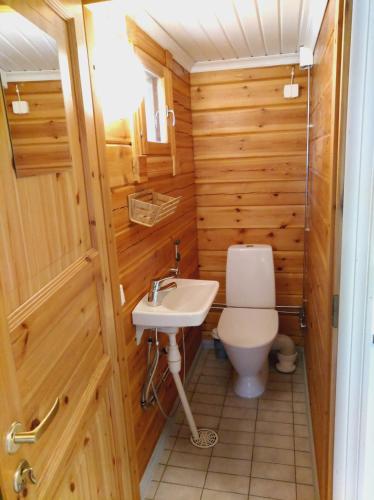 a bathroom with a toilet and a sink at Päiväkulma in Naantali