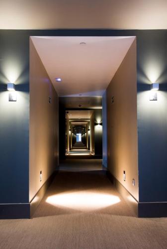 a hallway in a building with lights on the walls at Vincci Valdecañas Golf in El Gordo