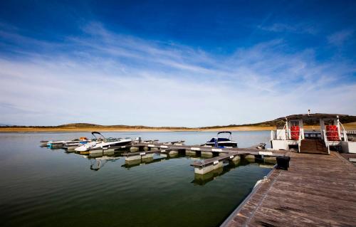 a dock with boats on a body of water at Vincci Valdecañas Golf in El Gordo