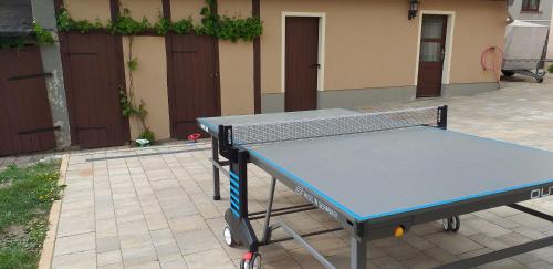 a blue ping pong table sitting on a patio at Ferienwohnung Radebeul Self Check-in in Radebeul