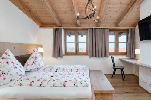 a bedroom with a bed and a table at Seehof am Waginger See in Petting