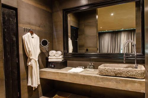 a bathroom with a sink and a large mirror at Casa Malca in Tulum