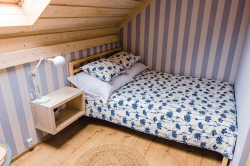 a small bedroom with a bed in a room at Apartamenty-Obok in Zator