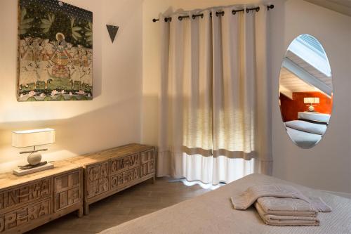 a bedroom with a bed and a mirror at Agriturismo l'Adagio in Badalucco