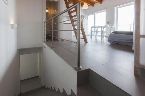 a staircase in a room with a living room at Sea View Apartment Carrapateira in Carrapateira