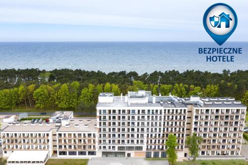 a hotel with the logo of beehive hotel at Blue Marine Mielno in Mielno