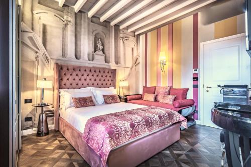 a bedroom with a large bed and a couch at Arte' Boutique Hotel in Florence
