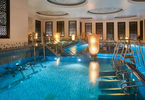 a pool in a hotel with stairs and a swimming pool at Crowne Plaza Kuwait Al Thuraya City by IHG in Kuwait