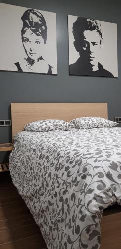 a bedroom with a bed with black and white sheets at PICASSO CALLAO WiFi FREE in Madrid