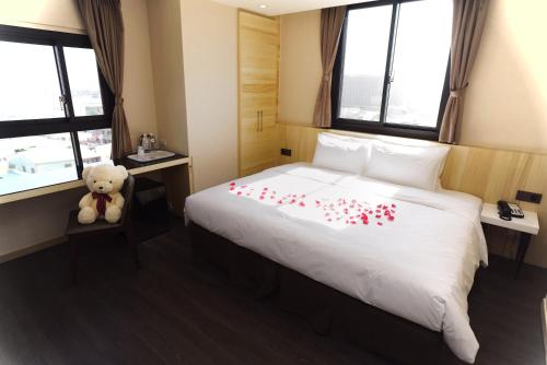 a bedroom with a white bed with red hearts on it at Red hotel in Yuanlin