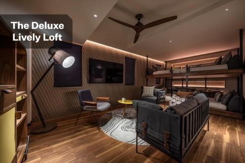 a living room with a couch and a crib in a room at THE LIVELY FUKUOKA HAKATA in Fukuoka
