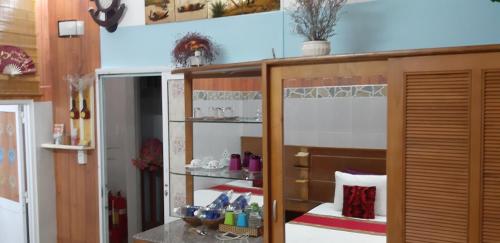 a room with a shelf with items on it at Homstay Thanh Sơn in Con Dao