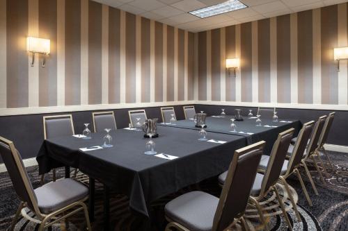 a conference room with a long table and chairs at Wyndham Phoenix Airport - Tempe in Tempe